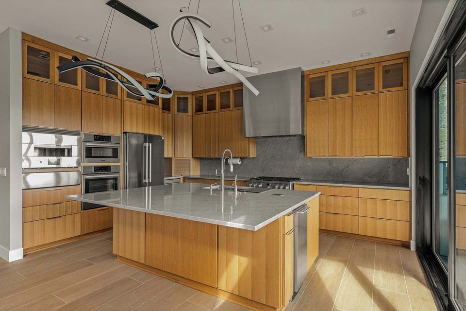 Modern kitchen with island, built in pizza oven, microwave, oven, fridge, drink drawers, wine fridge, dedicated ice machine and gas range. A kitchen for a true chef. Espresso machine, coffee maker and kettle as well.