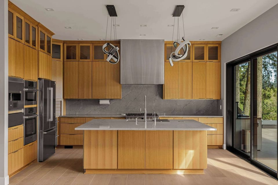 The open modern kitchen with pizza oven, dedicated ice machine, wine fridge, drill coolers and kitchen built for a chef. 