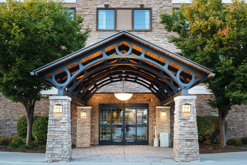 Stone arch entrance with decorative lighting above the main front doors