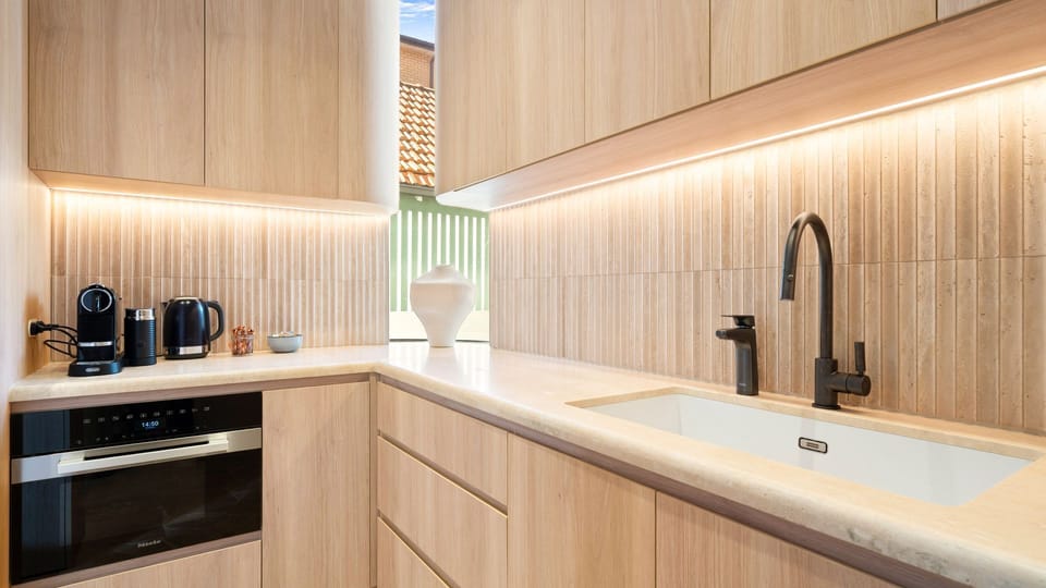 Sleek cooking space with modern appliances and ambient lighting.