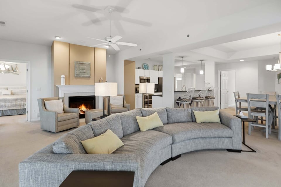 Spacious open-concept living area with a cozy fireplace and plenty of room to relax, dine, and gather together.