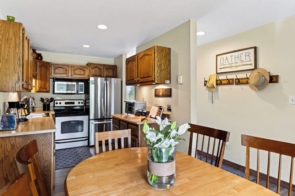 Fully equipped kitchen with stainless steel appliances and ample workspace.