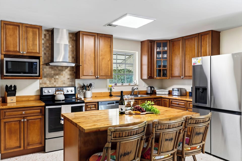 Prepare meals in the well-equipped kitchen, featuring a spacious island with seating for four.