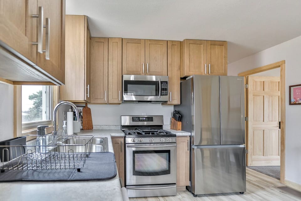 Compact kitchen with complete cookware and convenient layout.