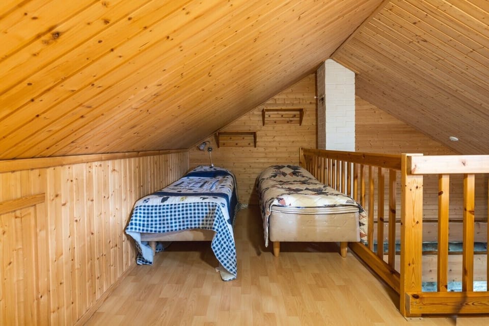 Loft sleeping area with two single beds, perfect for children.