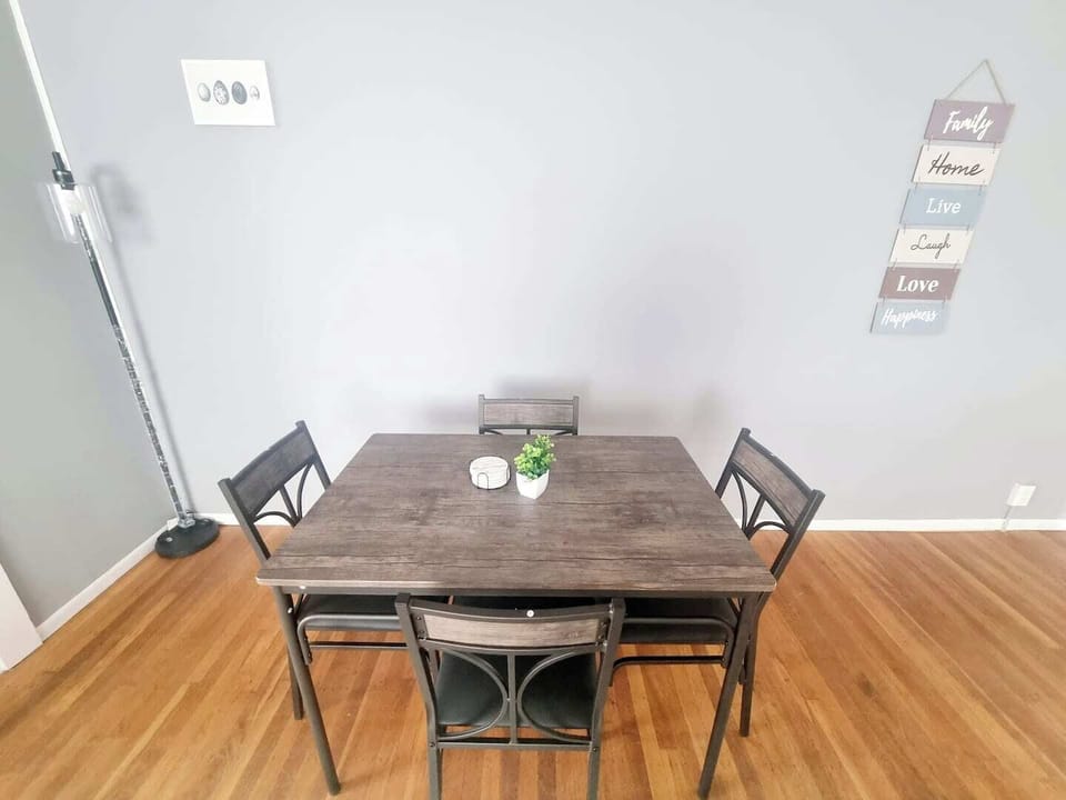The living room comes furnished with essential pieces, including a comfortable sofa, a coffee table, TV stand, and dining table, providing immediate comfort upon move-in.
