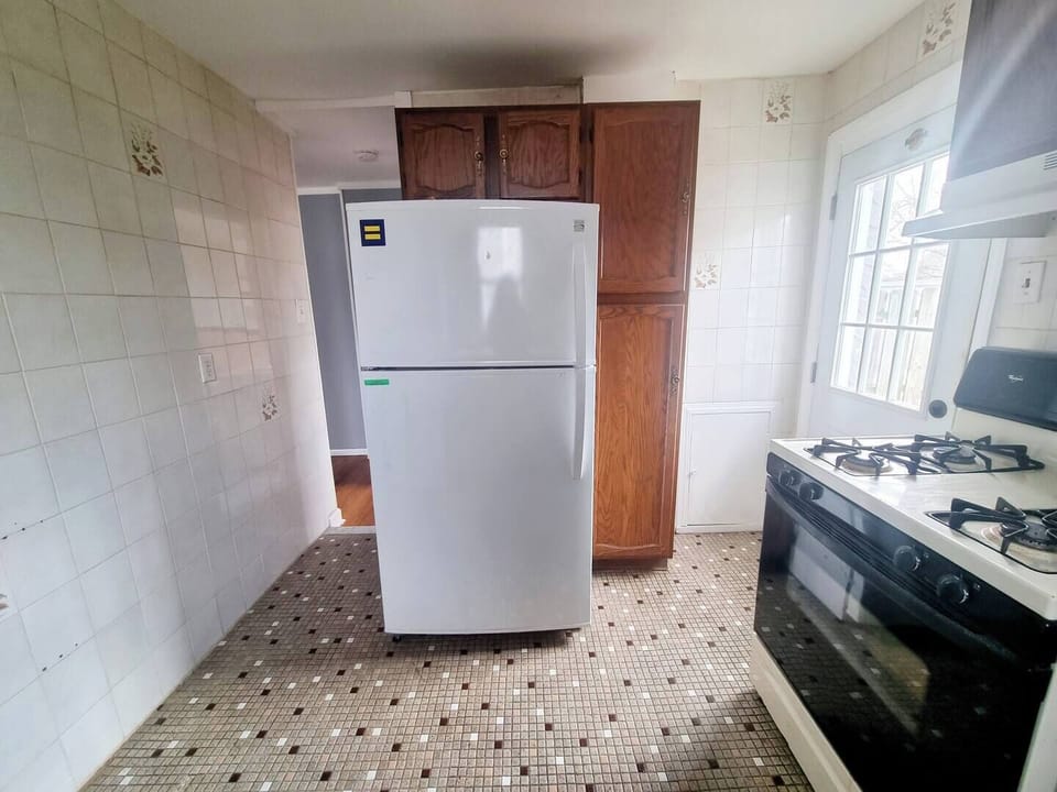 Step into a well-appointed kitchen designed for convenience. It includes a full-sized refrigerator, range, and plenty of counter space for meal prep. You'll find generous storage in the cabinetry, making it easy to keep things organized.
