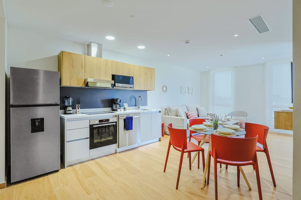 Your open-concept living space features a modern kitchen and a dining area that flows seamlessly into a cozy lounge—perfect for relaxed mornings and meals shared with loved ones.
