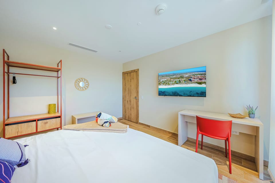 Your bright, modern bedroom offers a peaceful retreat with warm wood floors, a comfortable bed, and your own workspace. Air-conditioned comfort and thoughtful design await.