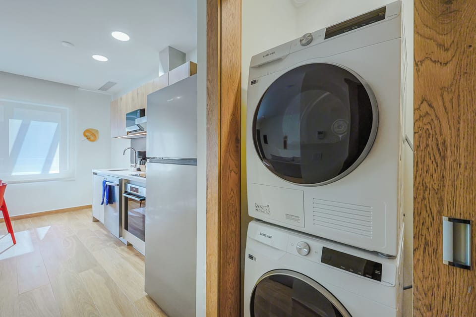 Enjoy the convenience of your own in-unit washer and dryer, tucked neatly beside your fully equipped kitchen—perfect for keeping fresh towels and linens at hand.