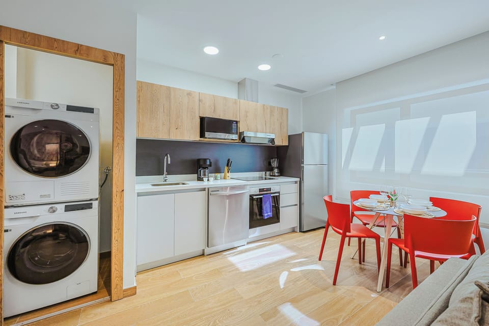 Your modern kitchen and dining space is bright and functional, with everything you need for a comfortable stay—including an in-unit washer and dryer for ultimate convenience.