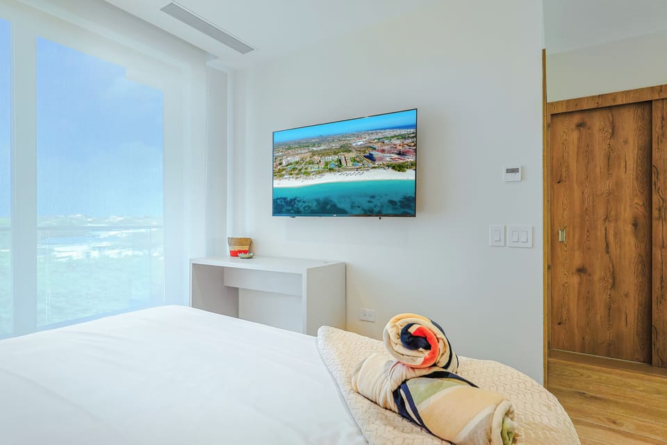 Sink into crisp linens in your bright, modern bedroom with ocean views and contemporary comforts awaiting your arrival.