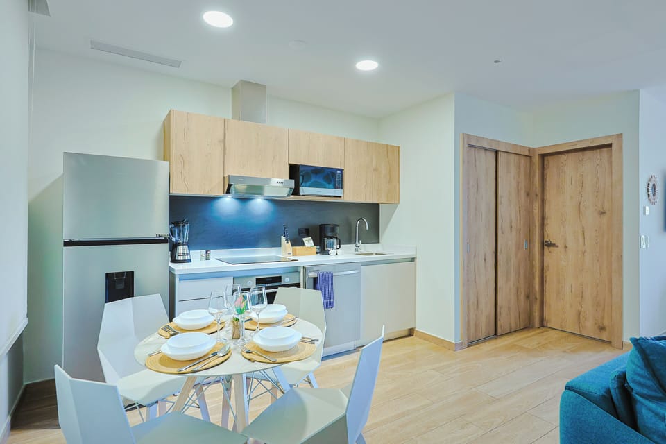 Your modern kitchen offers sleek cabinetry, a stylish backsplash, and thoughtful amenities—perfect for easy meal prep or a relaxed breakfast around the bright dining table.