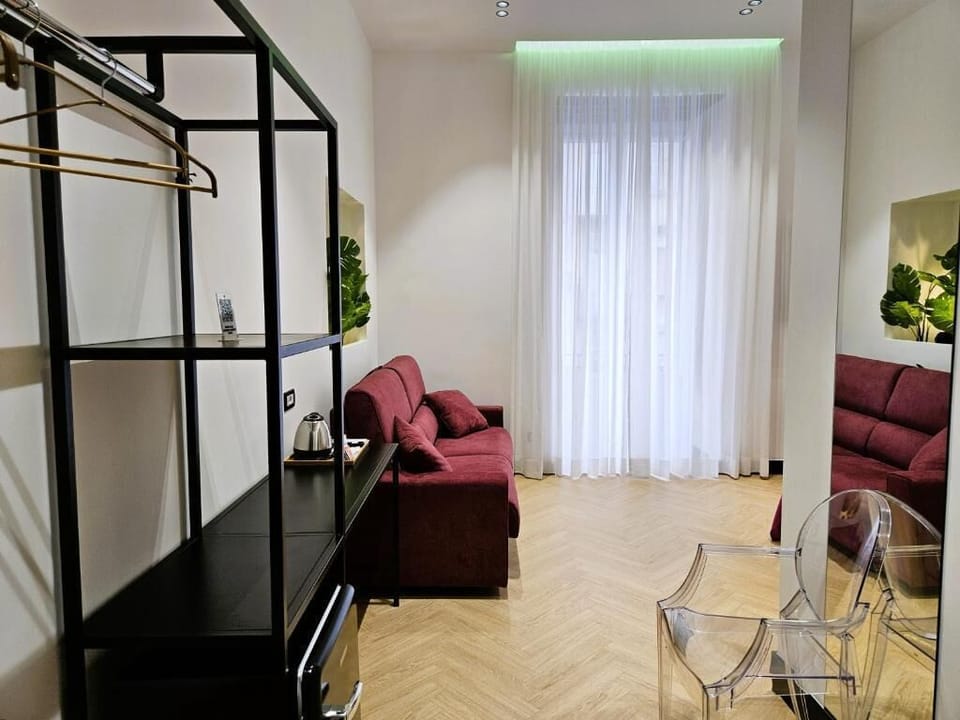 Luxury Quadruple Room | Living area | TV