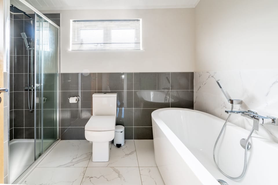 Ground floor: Bathroom with free standing bath and shower cubicle