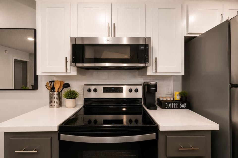Functional kitchen with oven, stove, fridge and basic cooking ware