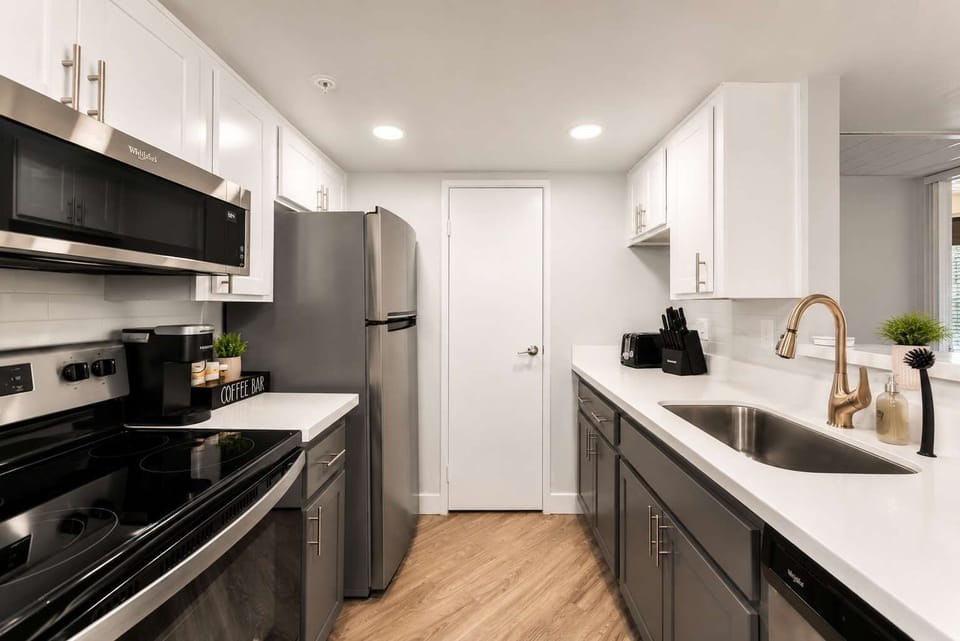Functional kitchen with oven, stove, fridge and basic cooking ware