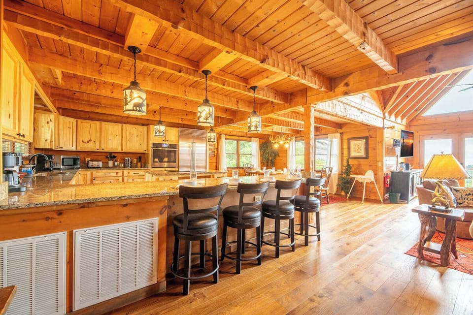 Soaring timber beams and a chef's kitchen create the perfect mountain gathering space. Natural wood, granite counters, and open comfort make this getaway warm and inviting.