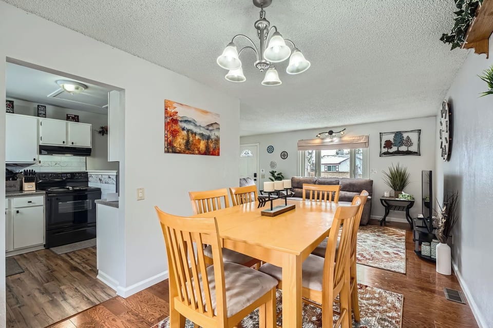 Gather around the dining table for meals with loved ones, then relax in the open living room nearby. The kitchen stands ready for your culinary adventures.