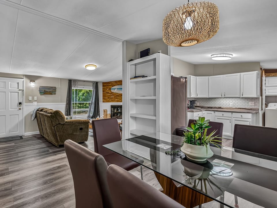 Glass-top table doubles as a spot for meals or board game nights.