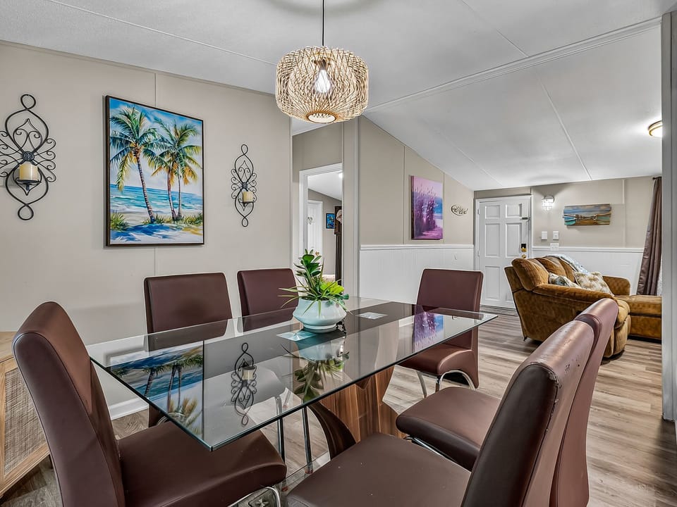 White cabinetry pairs with stainless steel appliances and dark countertops in the kitchen.