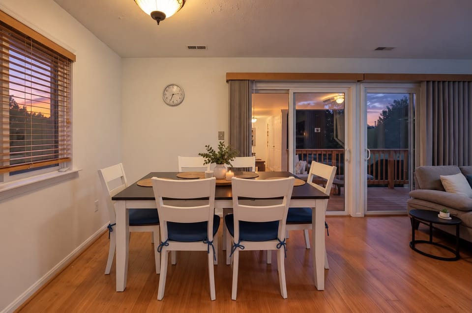 Bright dining area with deck access and beautiful sunset views