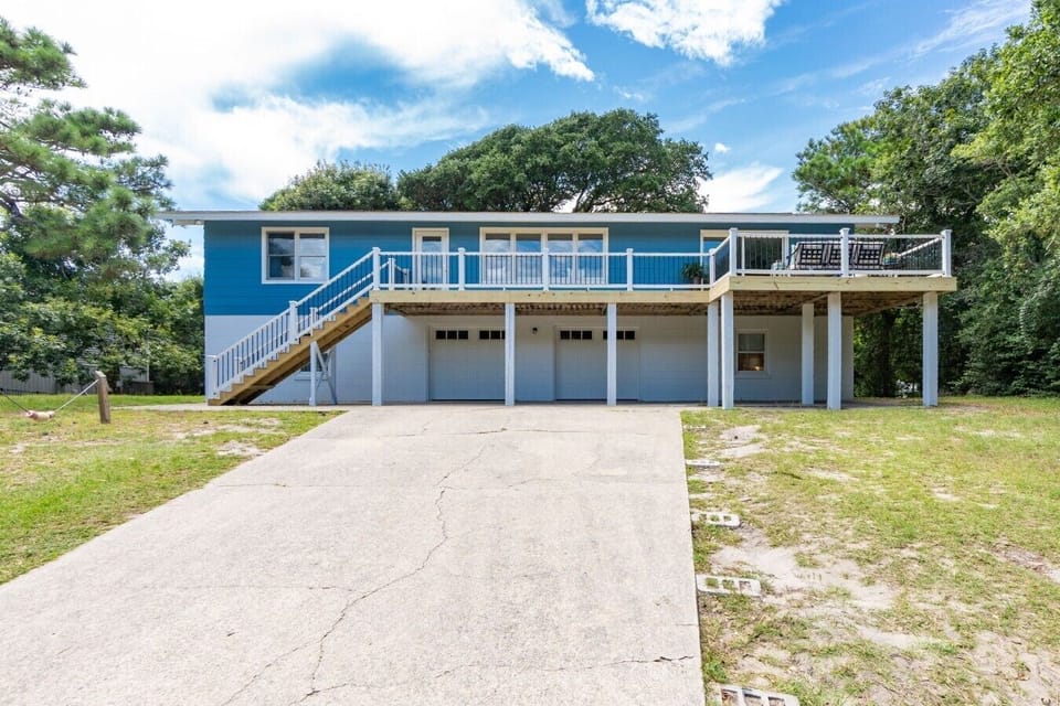 Your week starts here: the blue beach house under the live oaks, two houses back from the beach road.