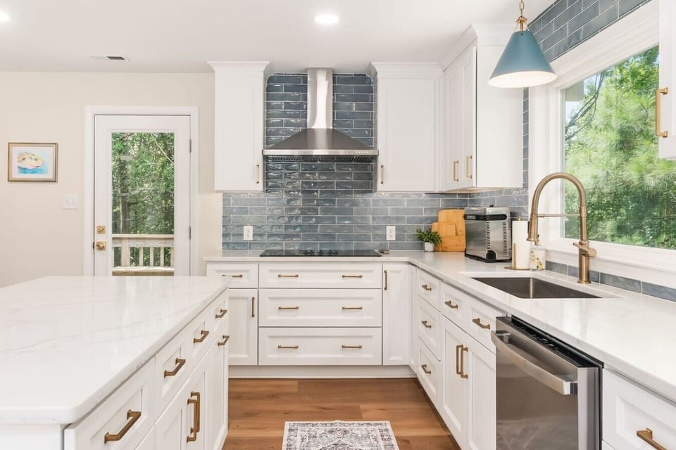 Induction cooktop, oven, and counter space for three cooks at once.