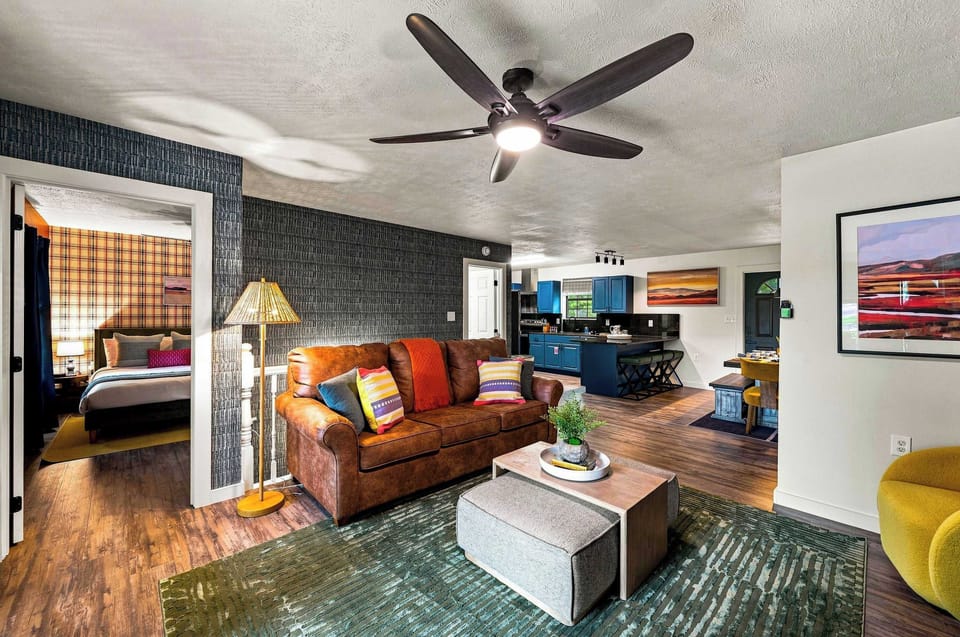 Sink into the leather sofa in this vibrant, retro-chic living space — playful color at every turn.