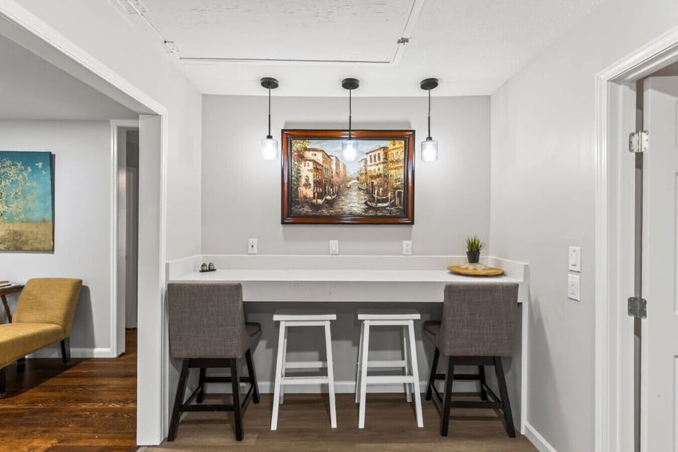 Pendant lighting brightens the breakfast bar, an inviting spot for coffee, snacks, or laptop time.
