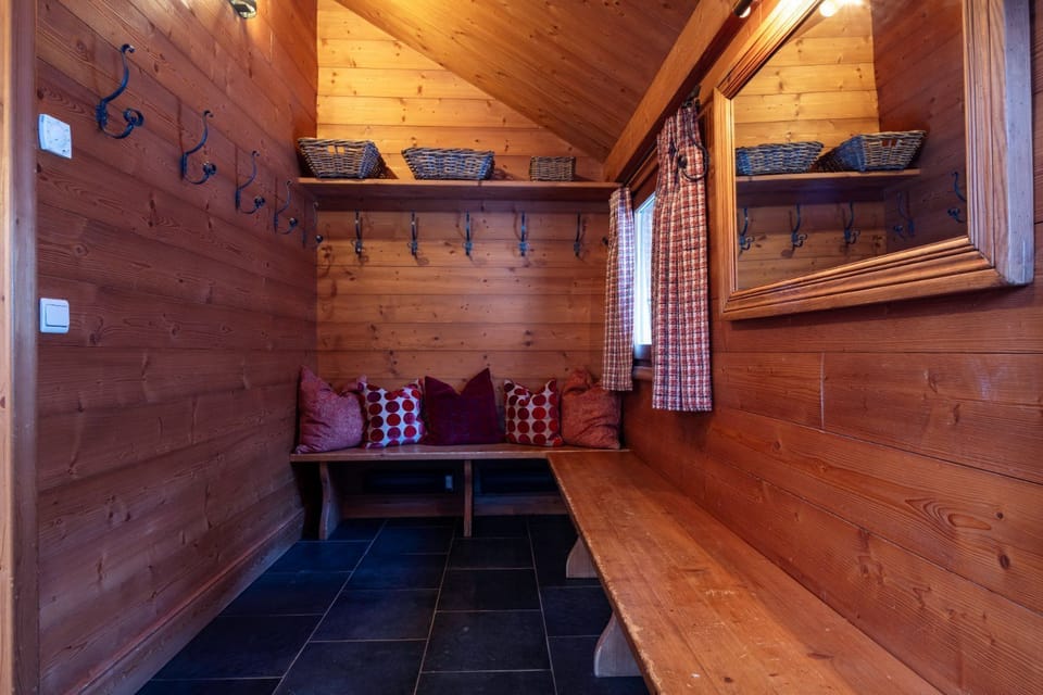 Benches and gear hooks line this room, ready to store skis and boots after a day outdoors.