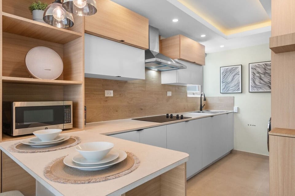 Stylish kitchen with modern cabinetry, microwave, cooktop, and everything needed for preparing meals during your stay.