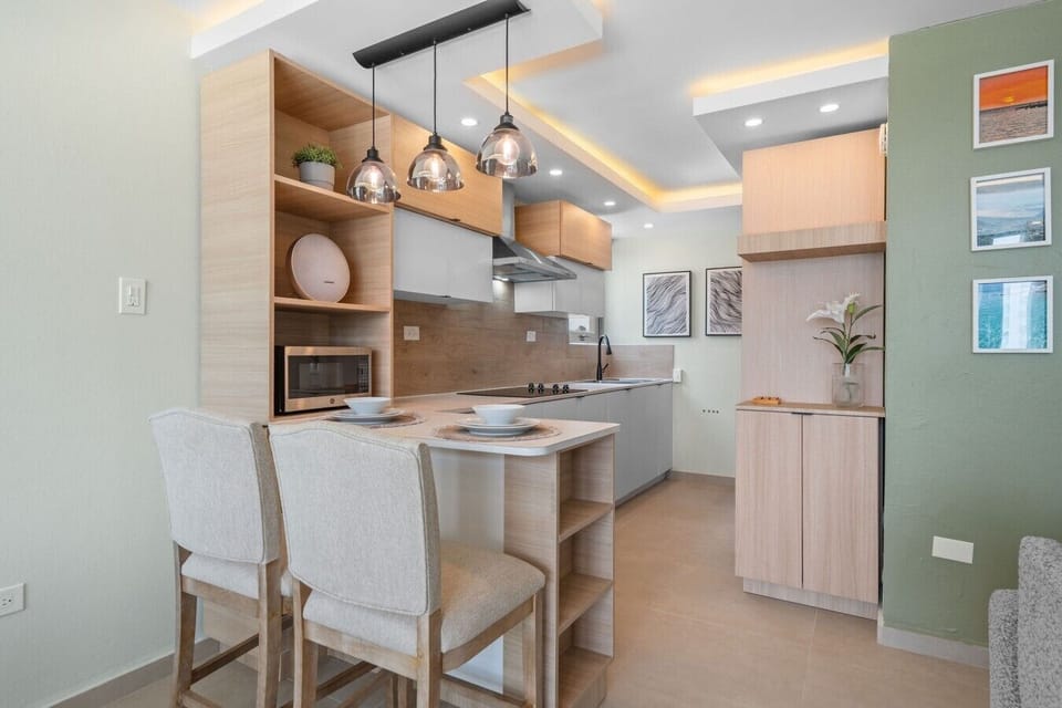 Modern, fully equipped kitchen with sleek cabinetry, generous counter space, and breakfast seating.
