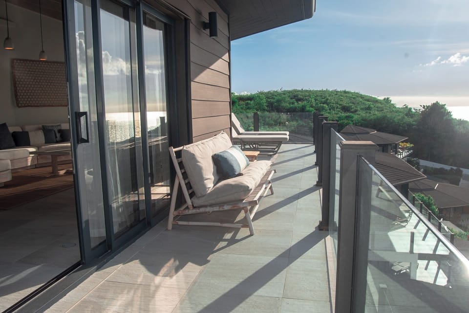 Sip sunset drinks on the balcony with sweeping coastal views.