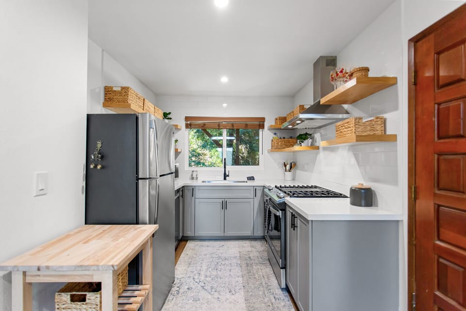 Stainless-steel appliances, cooking essentials, and easy access to the dining area.