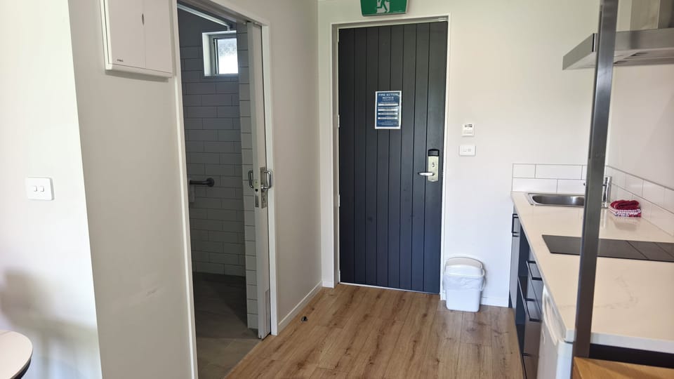 Accessible shower with folding seat, adjustable shower head and grab rails