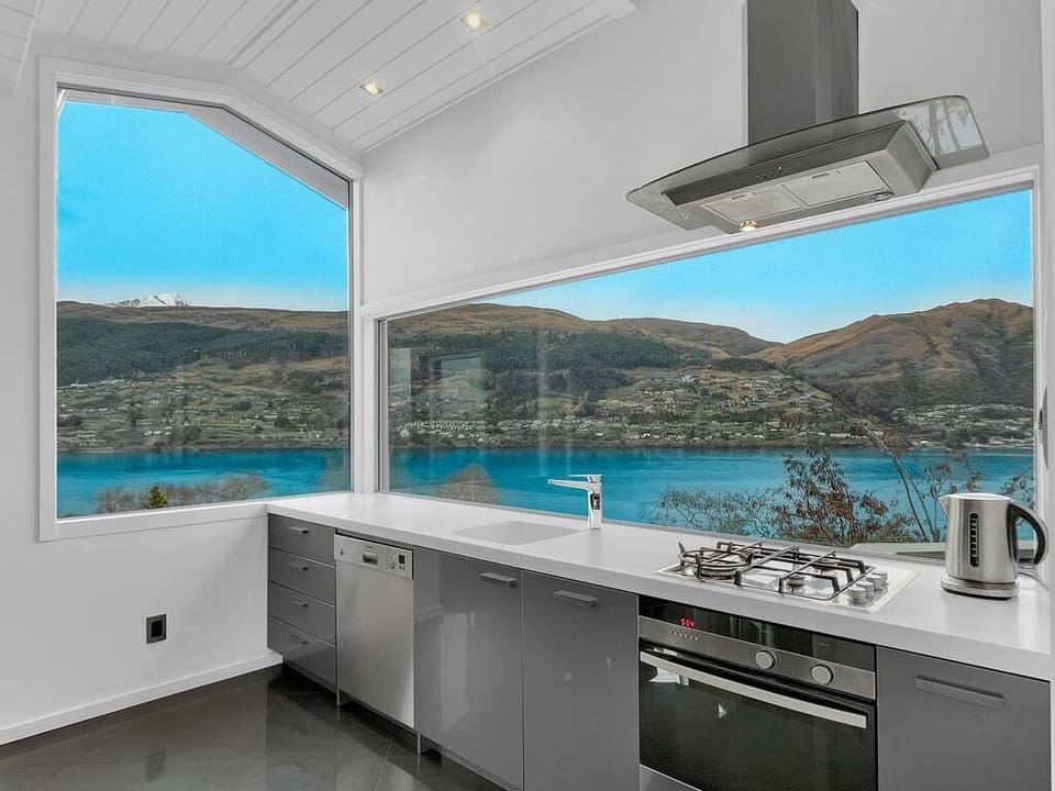 Modern kitchen with quality appliances and uninterrupted lake views.