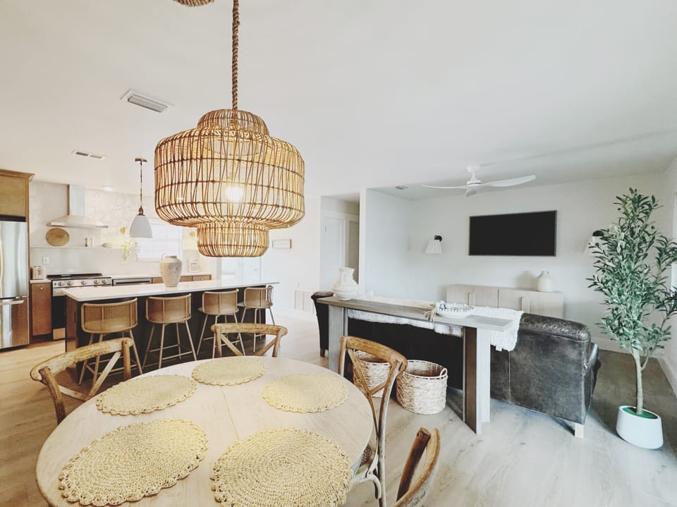 Bright open-concept dining, kitchen, and lounge with coastal charm