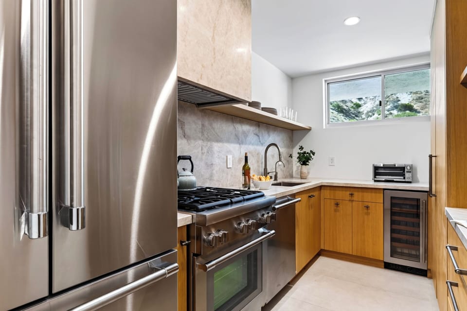 Fully equipped kitchen with modern appliances and ample workspace.