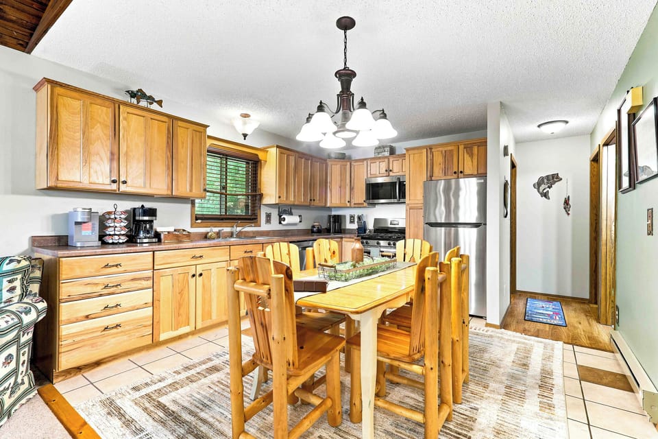 Fuel up for a day of outdoor adventure in this welcoming kitchen, outfitted with a sleek stainless steel refrigerator, coffee maker, and gas range. Gather everyone at the log dining table to plan your daily itinerary over breakfast.