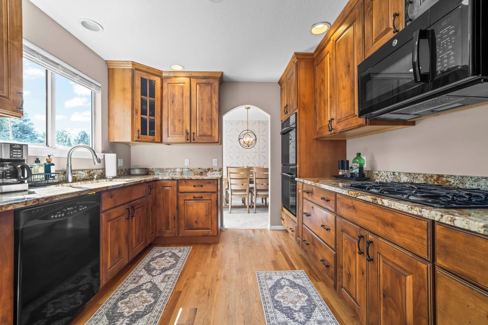 Warm wood cabinetry creates a welcoming kitchen with plenty of storage and workspace.