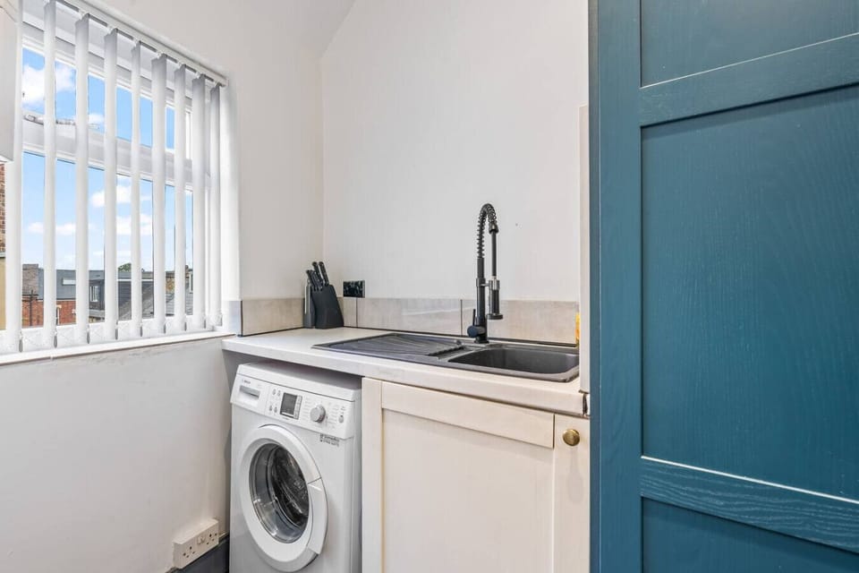 A convenient washing machine is available at the property, making it easy to take care of your laundry during your stay. (Rich Property Management)