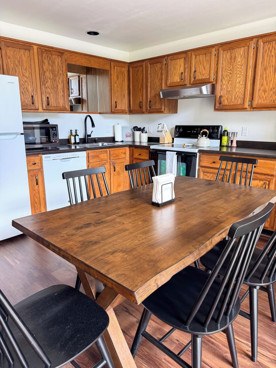 Spacious eat-in kitchen with seating for 6 and warm wood finishes