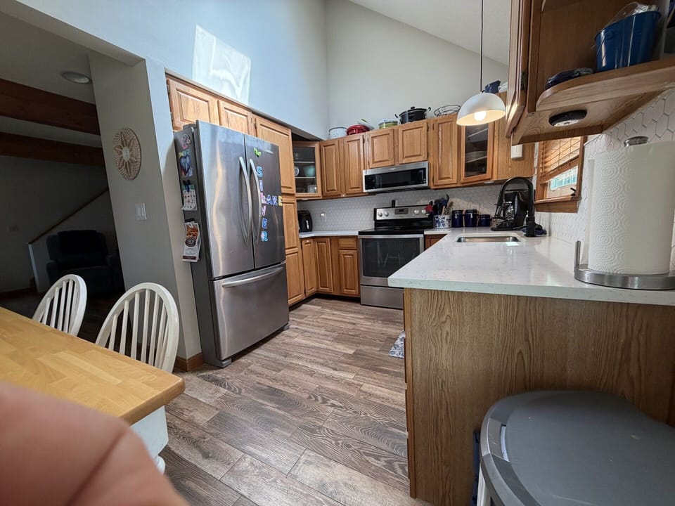 Your fully equipped kitchen awaits with modern appliances, ample counter space, and warm wood cabinetry—perfect for preparing meals together during your stay.