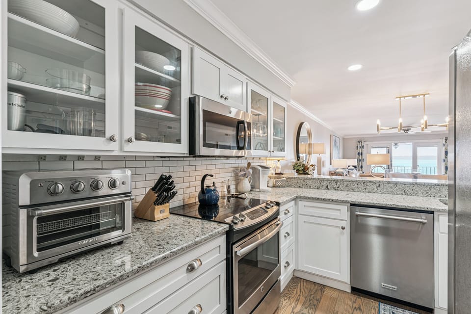 Your gourmet kitchen features granite counters, stainless appliances, and gleaming white cabinets—perfect for creating memorable meals together.