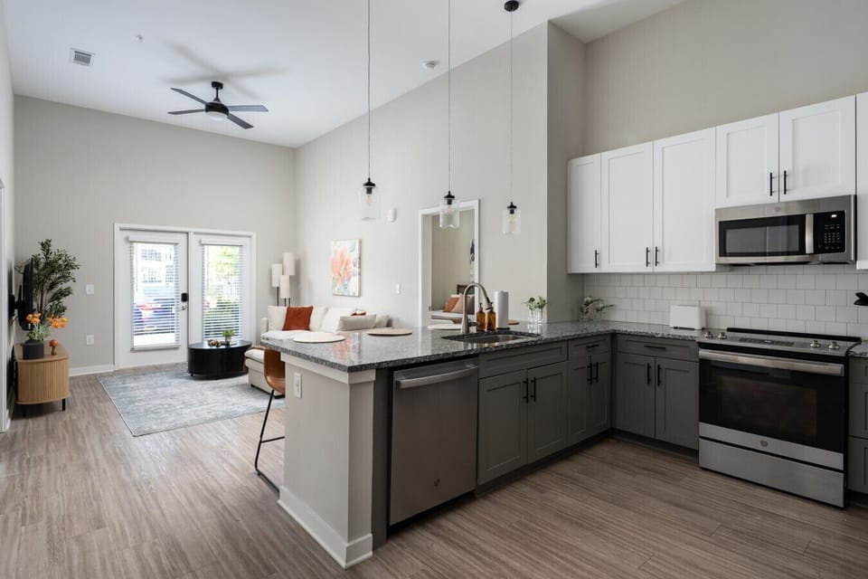 Welcome to our open kitchen! Fully equipped with sleek stainless steel appliances and ample counter space, it`s perfect for cooking and quick meals.