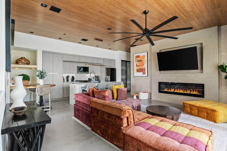 Living room with smart TV and electric fireplace to set the ambiance for a romantic night in