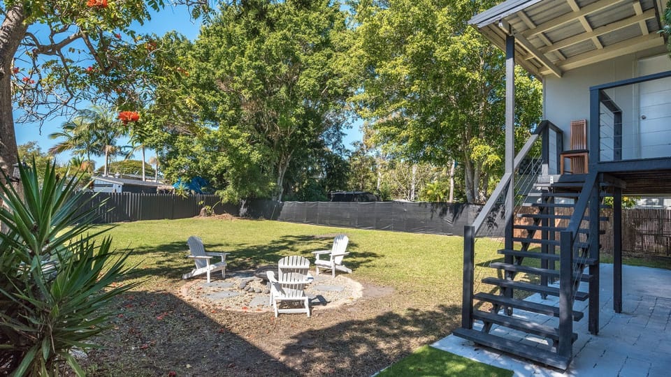 Outdoor entertaining area surrounded by established gardens.