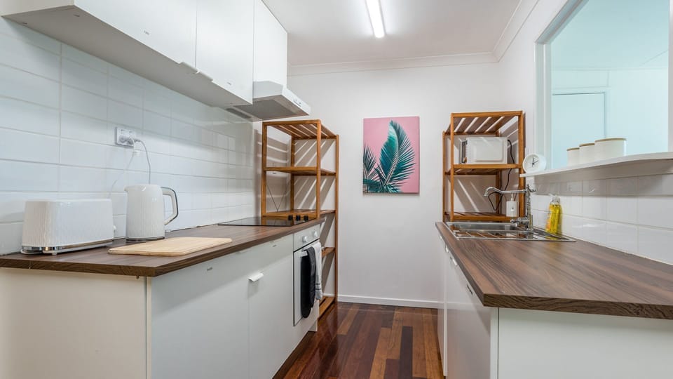 Well-equipped kitchen with generous bench space and essential appliances.