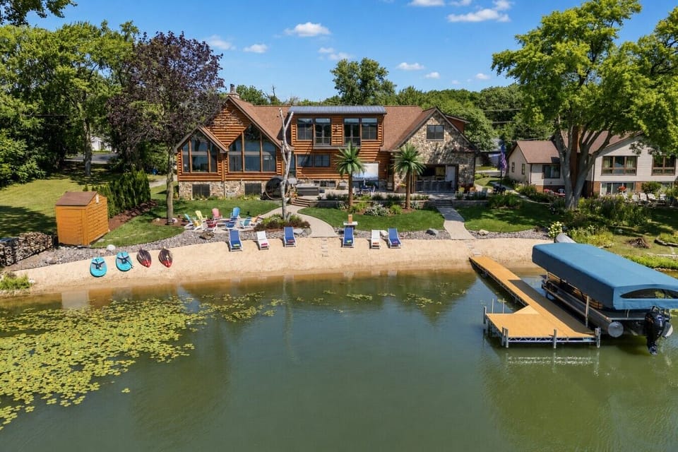 The complete lakefront experience: sandy beach, private dock, fire-pit seating, kayaks and paddleboards. Pontoon charters are optional.